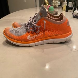Orange nike athletic shoes